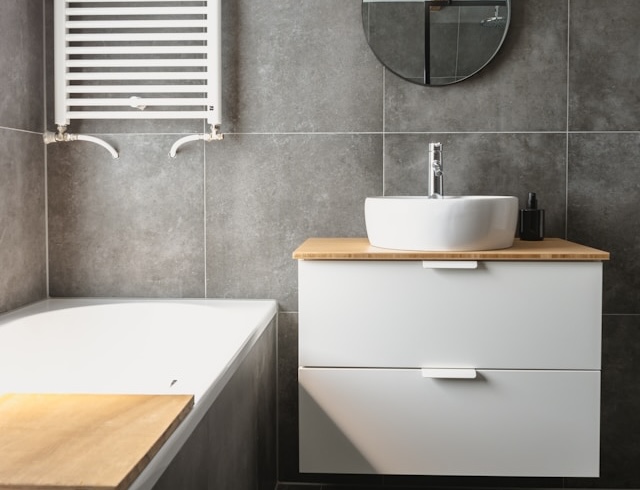 white ceramic bathtub next to white ceramic bathtub